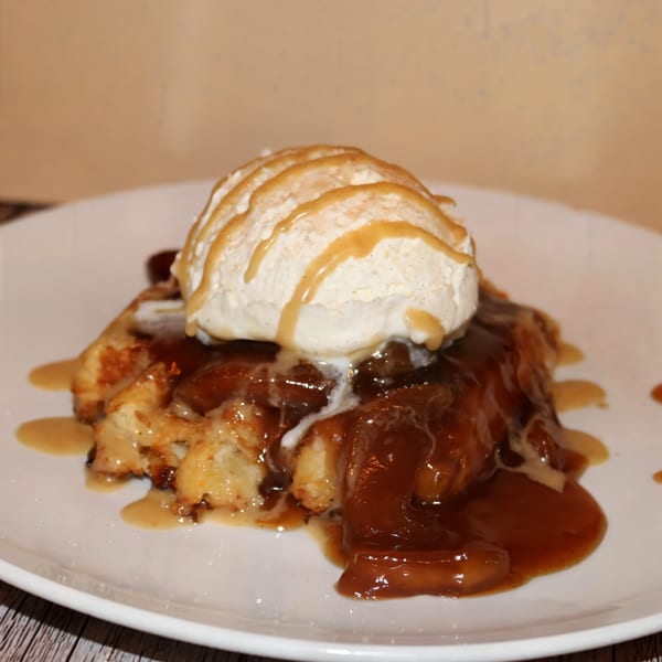 Water Street Waffle Co's apple waffle dessert, topped with vanilla ice cream and caramel sauce.